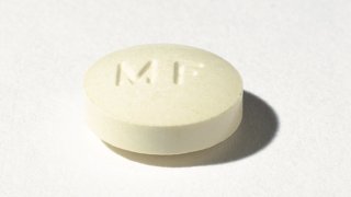 A round, cream-colored Mifeprex tablet seen against a white background. Mifeprex and its generic version, mifepristone, is also known as the abortion pill.