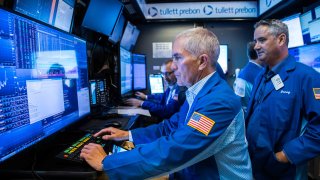 Traders work on the floor of the New York Stock Exchange.