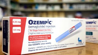 In this photo illustration, a box of the diabetes drug Ozempic rests on a pharmacy counter on April 17, 2023