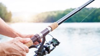 Hand holding fishing rod
