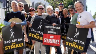 Cast and writers from "Breaking Bad" and "Better Call Saul" pose on a picket line outside Sony Pictures studios