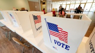 Empty poll kiosks await voters at the Mississippi Second Congressional District Primary election precinct June 7, 2022, in Jackson, Miss.