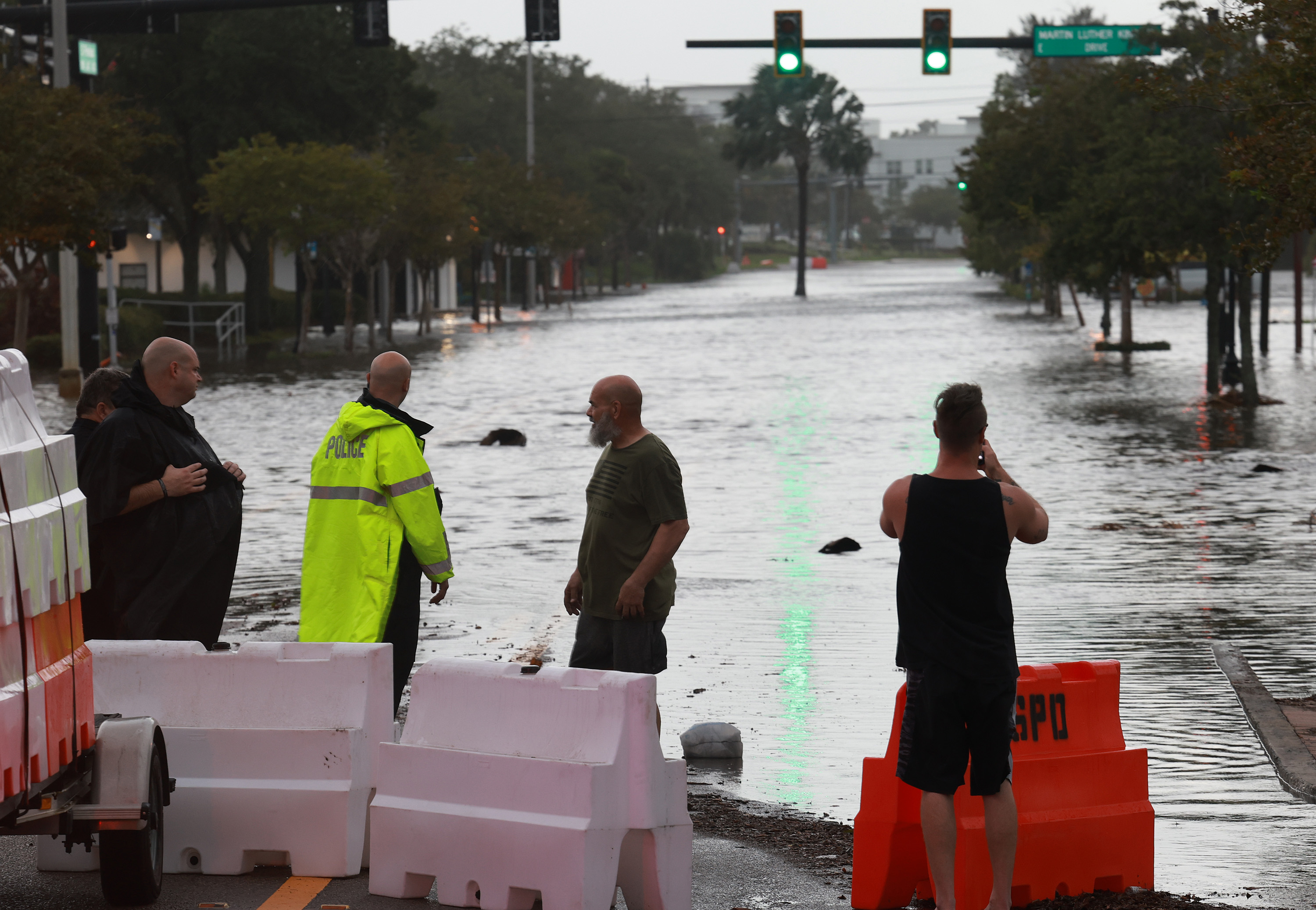 Police man a roadblock to keep cars from driving through flood waters on Aug. 30, 2023, in Tarpon Springs, Florida. Hurricane Idalia slammed into Florida’s West Coast as a category 3 storm early Wednesday morning.