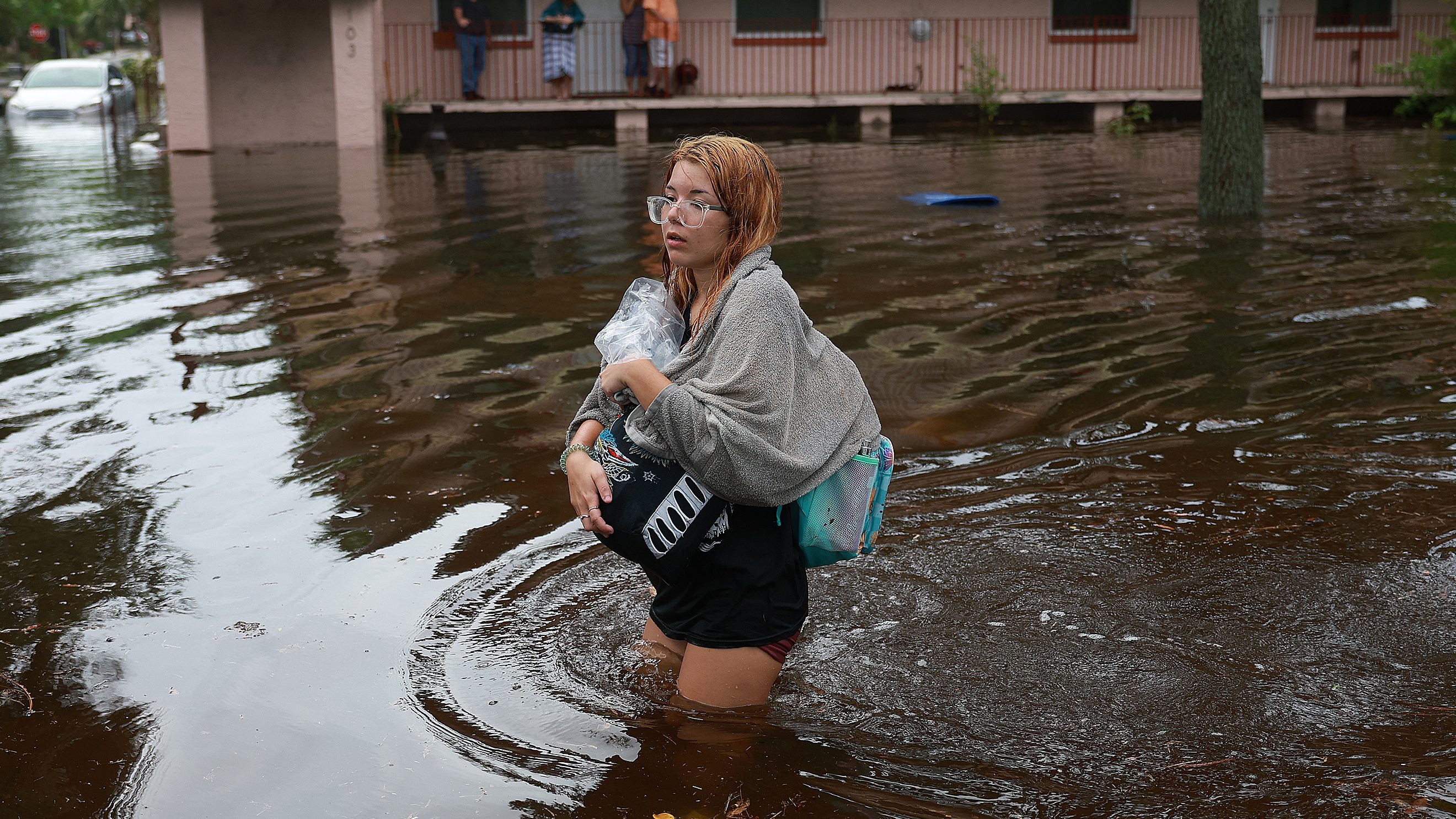 Makatla Ritchter evacuates her home through floodwaters caused by storm surge from Hurricane Idalia on Aug. 30, 2023, in Tarpon Springs, Florida.