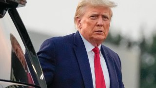 Former President Donald Trump walks to speak with reporters before departure from Hartsfield-Jackson Atlanta International Airport, Thursday, Aug. 24, 2023, in Atlanta.