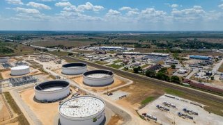 In an aerial view, oil storage tanks are shown at the Enterprise Sealy Station on August 28, 2023 in Sealy, Texas.