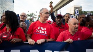 United Auto Workers President Shawn Fain (center) marches with UAW members through downtown Detroit after a rally in support of the union’s members as they strike the Big Three automakers, Detroit, Michigan, Sept. 15, 2023.