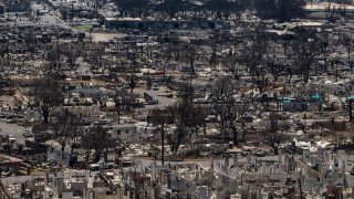 FILE - Charred remains of homes are visible following a wildfire in Lahaina, Hawaii, Aug. 22, 2023.