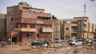 cars and rubble sit in a street in Derna, Libya, on Monday, Sept. 11, 2023, after it was flooded by heavy rains.