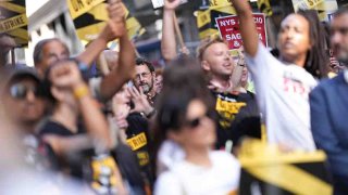 FILE - Tony Kushner (C) and SAG-AFTRA and WGA members on strike on Sept. 14, 2023, in New York City.