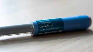 An Ozempic (semaglutide) injection pen is seen on a kitchen table.