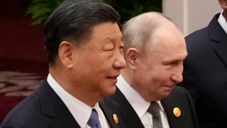 Chinese President Xi Jinping and Russian President Vladimir Putin prepare for a group photo with other leaders at the third Belt and Road forum on Oct. 18, 2023, in Beijing.