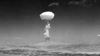 In this April 22, 1952 file photo, a gigantic pillar of smoke with the familiar mushroom top climbs above Yucca Flat, Nev.