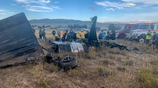 FILE – In this photo provided by Truckee Meadows Fire & Rescue, in Reno, Nev., members of Truckee Meadows Fire & Rescue and other officials look over aircraft wreckage, Sunday, Sept. 17, 2023, in Reno.