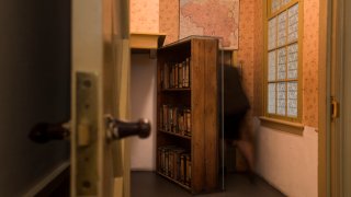 FILE - A woman enters the secret annex at the renovated Anne Frank House Museum