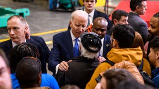 Biden greets people after speaking during a visit to the Cummins Power Generation facility