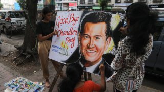 Students paint a portrait to pay tribute to late Actor Matthew Perry following his death, outside an art school in Mumbai, India,