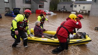 Members of the emergency services help local residents to safety in Brechin, Scotland, as Storm Babet batters the country.