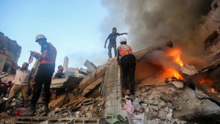 People search through buildings that were destroyed during Israeli air raids in the southern Gaza Strip November 4 2023 in Khan Yunis, Gaza. 