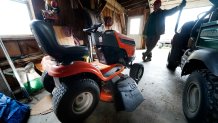 Trailer park owner Ed Smith looks at one of Geoffrey Holt's riding mowers at Stearns Park, Wednesday, Nov. 15, 2023, in Hinsdale, N.H.