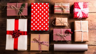christmas presents laid on a wooden table