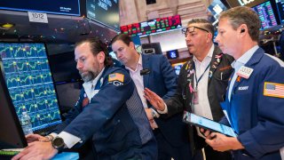 Traders work on the floor of the New York Stock Exchange. 