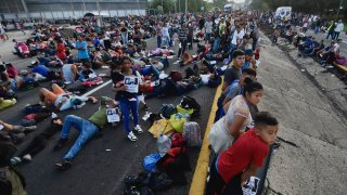 Migrants block the highway in Mexico's border