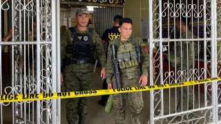 Military personnel stand guard at the entrance of a gymnasium after a bomb attack at Mindanao State University in Marawi, Lanao del sur province on December 3, 2023.