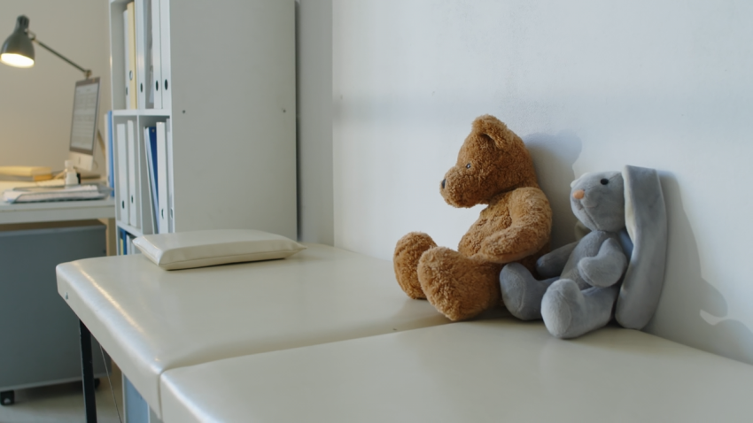 Teddy bears on exam table in doctor's office