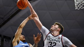 UConn center Donovan Clingan (32) blocks a shot by Creighton guard Trey Alexander (23) in the first half of an NCAA college basketball game.