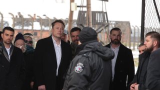 Tesla and SpaceX’s CEO Elon Musk, centre, walks during his visit to the site of the Auschwitz-Birkenau Nazi German death camp in Oswiecim, Poland, on Monday, Jan. 22, 2024. The private visit was apparently in response to calls from some Jewish religious leaders for Musk to see with his own eyes the most symbolic site of the horrors of the Holocaust.