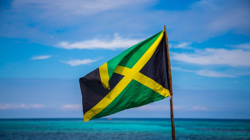 Jamaican flag in front of water