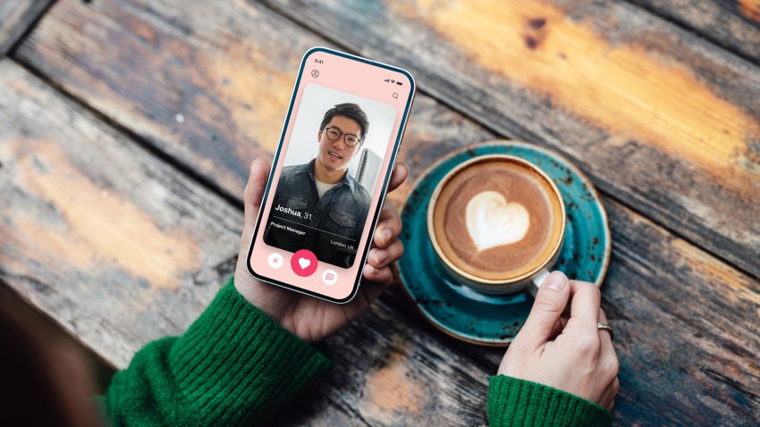 Elevated view of young woman looking for love with online dating app on smartphone while drinking coffee