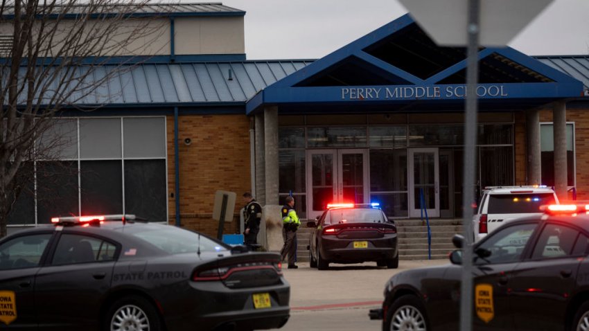 Police officers secure the campus at Perry Middle and High School