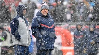 New England Patriots head coach Bill Belichick looks on in the snow before a game at Gillette Stadium in Foxborough, Massachusetts, on Sunday, Jan. 7, 2024.