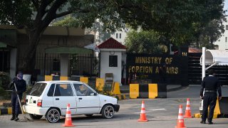 A Pakistani police officer checks a vehicle stand entering the Ministry of Foreign Affairs in Islamabad on January 18, 2024.