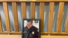 A bench honors Officer Joshua Castellano inside the New Haven Police Department.