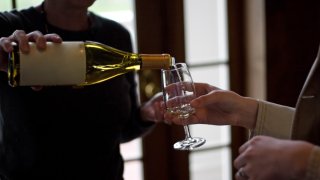 Closeup of some wine being poured during a wine tasting. 301048662