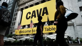 A banner for the Mediterranean restaurant chain Cava is displayed outside of the New York Stock Exchange (NYSE) as the company goes public on June 15, 2023 in New York City.
