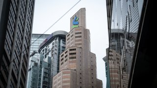 Signage atop the Standard Chartered Plc headquarters building, center, in Hong Kong, China, on Monday, Feb. 19, 2024.