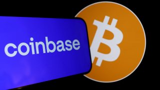The Coinbase and bitcoin logos are displayed on a phone screen in San Anselmo, California, on Feb. 15, 2024.