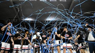 The UConn men's basketball team celebrates.