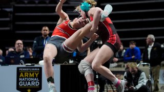 Easton's Aubre Krazer, right, takes down Hazleton Area's Miah Molinaro, left, during the first found of the PIAA High School Wrestling Championships in Hershey, Pa., Thursday, March 7, 2024. Girls’ wrestling has become the fastest-growing high school sport in the country. (AP Photo/Matt Rourke)