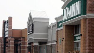 FILE – People walk into and out of a Joann store, Sept. 6, 2007, in Garfield Heights, Ohio. The fabric and crafts retailer has filed for Chapter 11 bankruptcy protection, as consumers continue to cut back on discretionary spending. In a Monday, March 18, 2024 release, the Hudson, Ohio-based company said that it expected to emerge from bankruptcy as early as the end of next month.