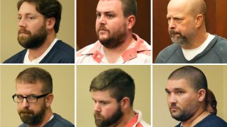 FILE – Michael Corey Jenkins, center, and Eddie Terrell Parker, right, listen as one of six former Mississippi law officers pleads guilty to state charges at the Rankin County Circuit Court in Brandon, Miss., Aug. 14, 2023.