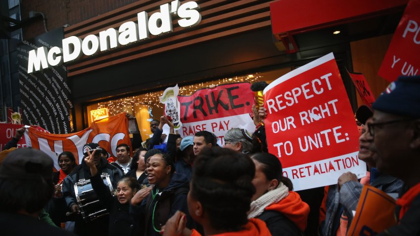 Protesters demonstrate at a McDonald’s in Midtown Manhattan on December 5, 2013 in New York, United States. Protesters staged events in cities nationwide, demanding a pay raise to $15 per hour for fast food workers and the right for them to unionize.