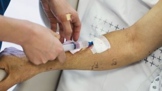 File - Patient having an intravenous drip inserted into their arm.