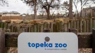 The Topeka Zoo and Conservation Center sign is pictured.