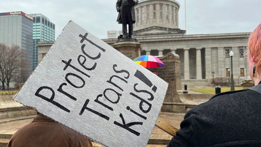 FILE – Demonstrators advocating for transgender rights and healthcare stand outside of the Ohio Statehouse on Jan. 24, 2024, in Columbus, Ohio. The rights of LGBTQ+ students will be protected by federal law and victims of campus sexual assault will gain new safeguards under rules finalized Friday, April19, 2024, by the Biden administration. Notably absent from Biden’s policy, however, is any mention of transgender athletes. (AP Photo/Patrick Orsagos, File)