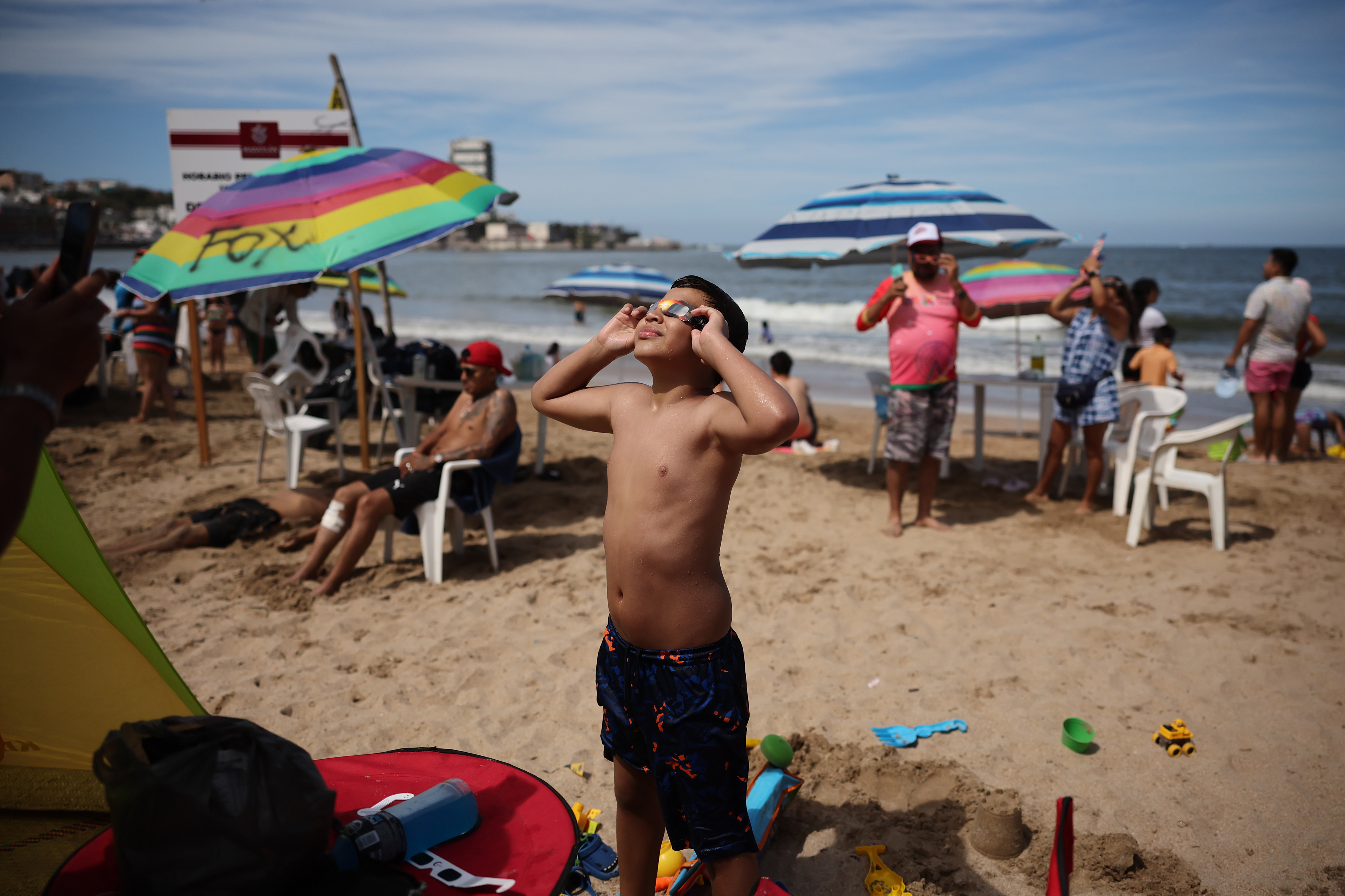 A child watches the eclipse from the beach on April 08, 2024 in Mazatlan, Mexico.